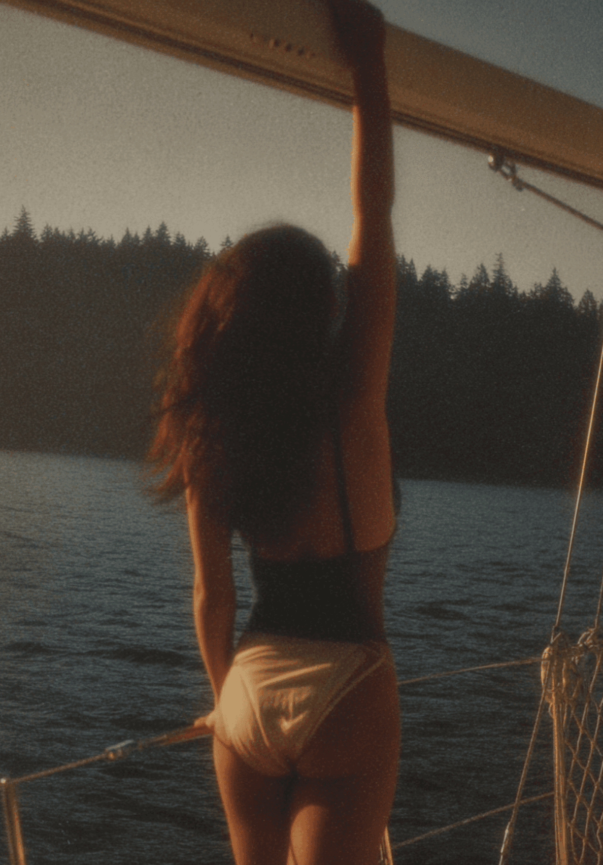 AI-generated silhouette on sailboat at dusk